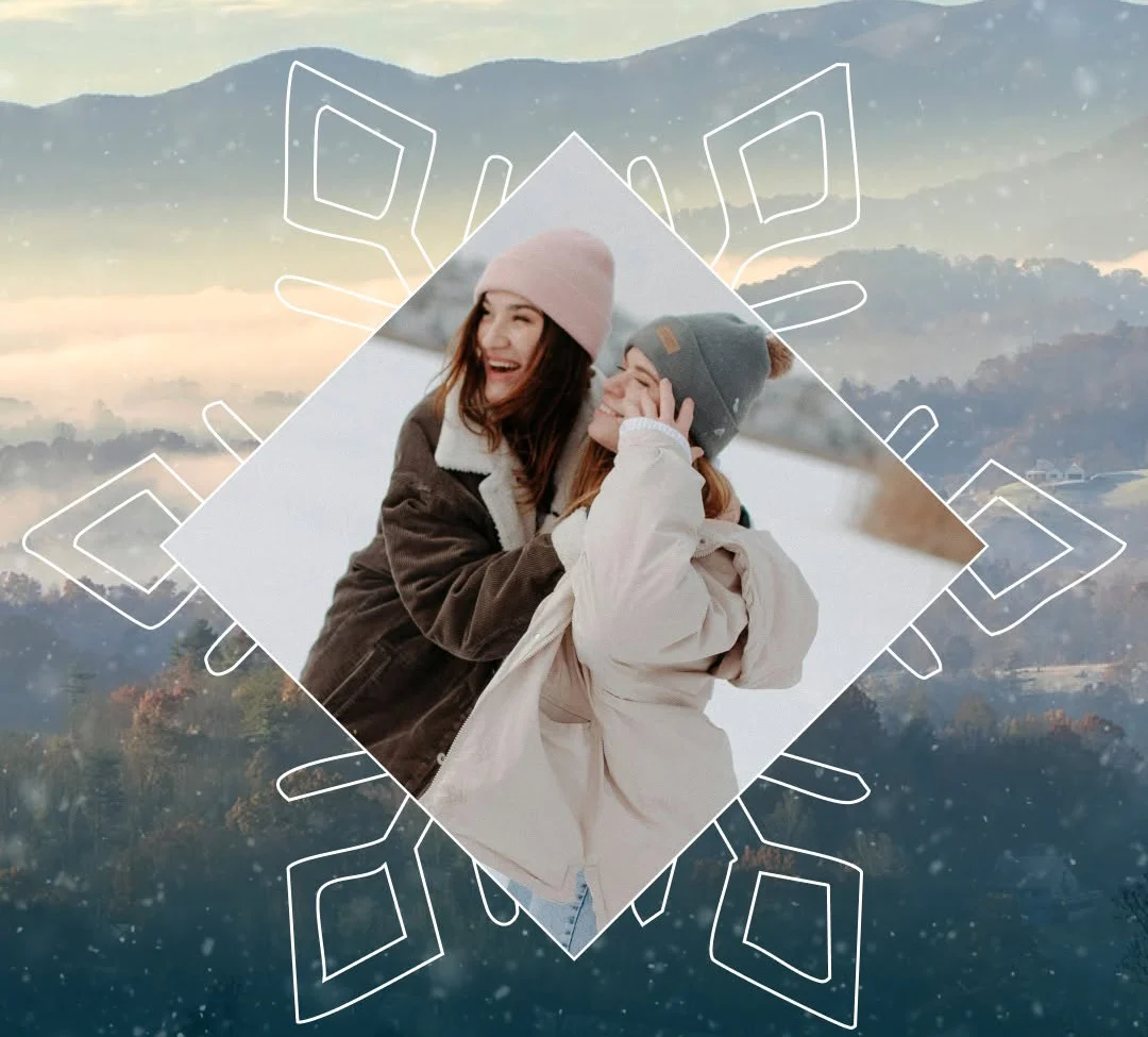 Two people in winter hats smile together in a diamond-shaped photo overlaying a snowy mountain landscape in Cherokee, NC, with decorative snowflake graphics in the background.