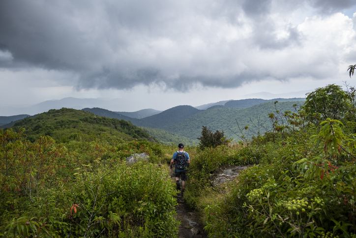 man hiking the black balsam knob and tennent mountain loop trail in north carolina