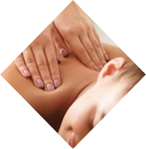 A close-up image of a person's hands massaging another person's back at a spa, focusing on the skin and hands in the act of giving a massage.