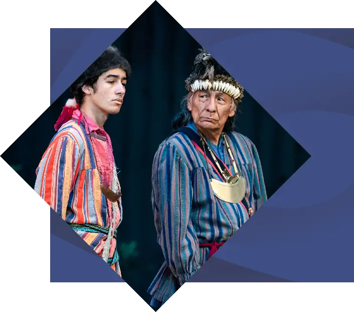 Two indigenous men in traditional attire, one younger looking to the side and one older with a feather headband, against a stylized geometric background inspired by "Unto These Hills.