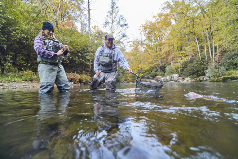 two people fishing in Cherokee with fishing gear