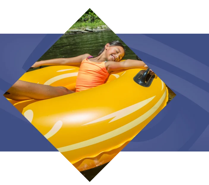Person floating in yellow inner tube with blue geometric background