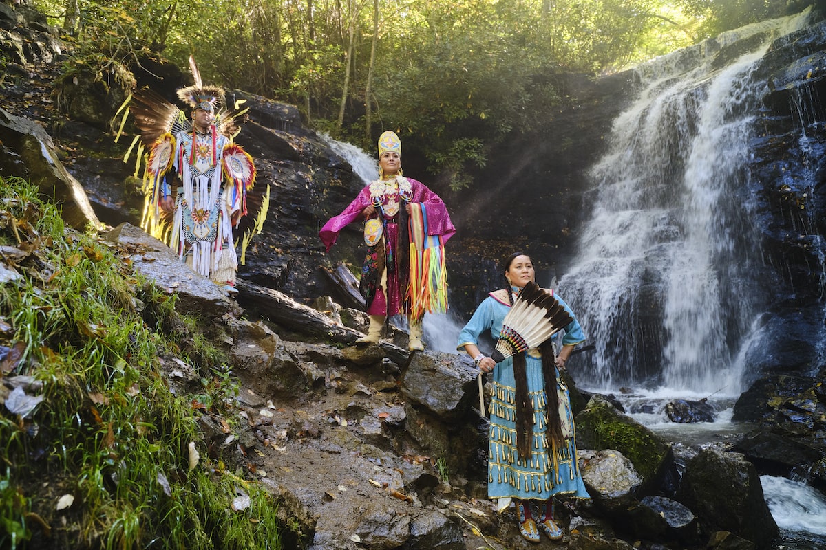 powwow dancers at a waterfall