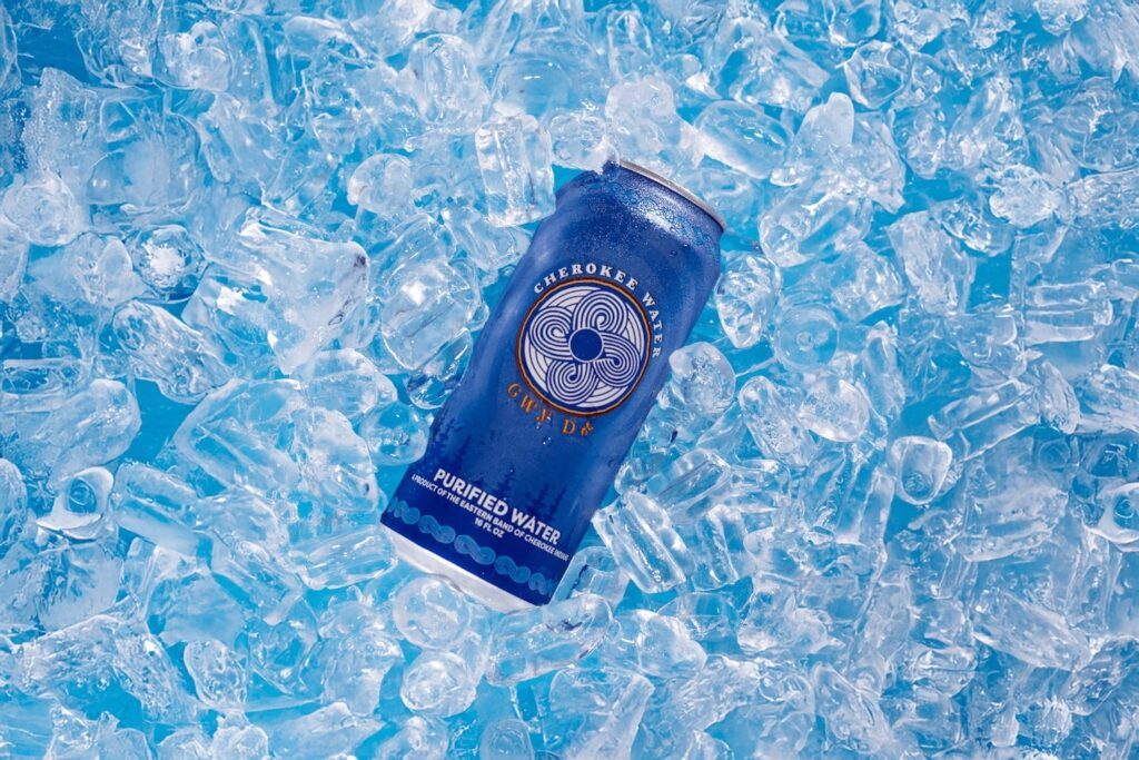 One can of Cherokee Canned Water sitting on top of a bed of ice