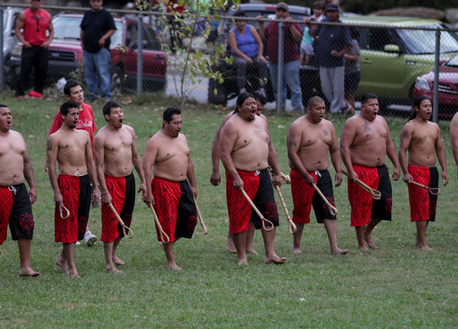 Adults getting ready to play stickball