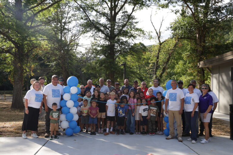 Community members, leaders, and children gathered for the official ribbon-cutting ceremony at the grand opening of Whitewater Landing park in Cherokee, NC